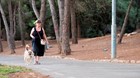 Woman walking dog in the park