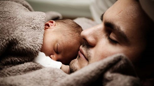 Father and baby asleep