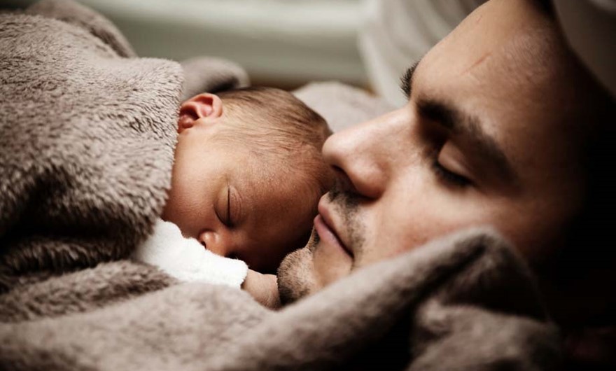 Father and baby asleep