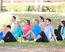 Children and adults exercising in the park