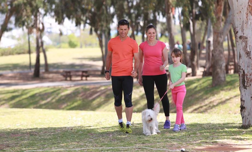 Family walking with the dog in the park